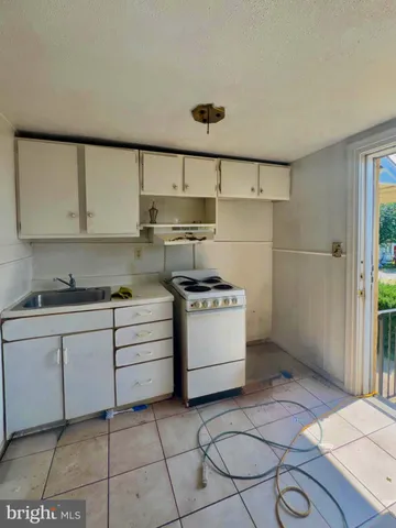 a kitchen with a stove a sink and a refrigerator