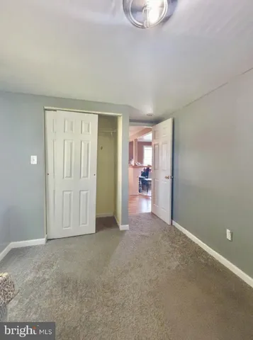 an empty room with furniture and a window