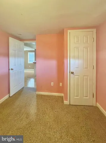 a view of an empty room with a bathroom