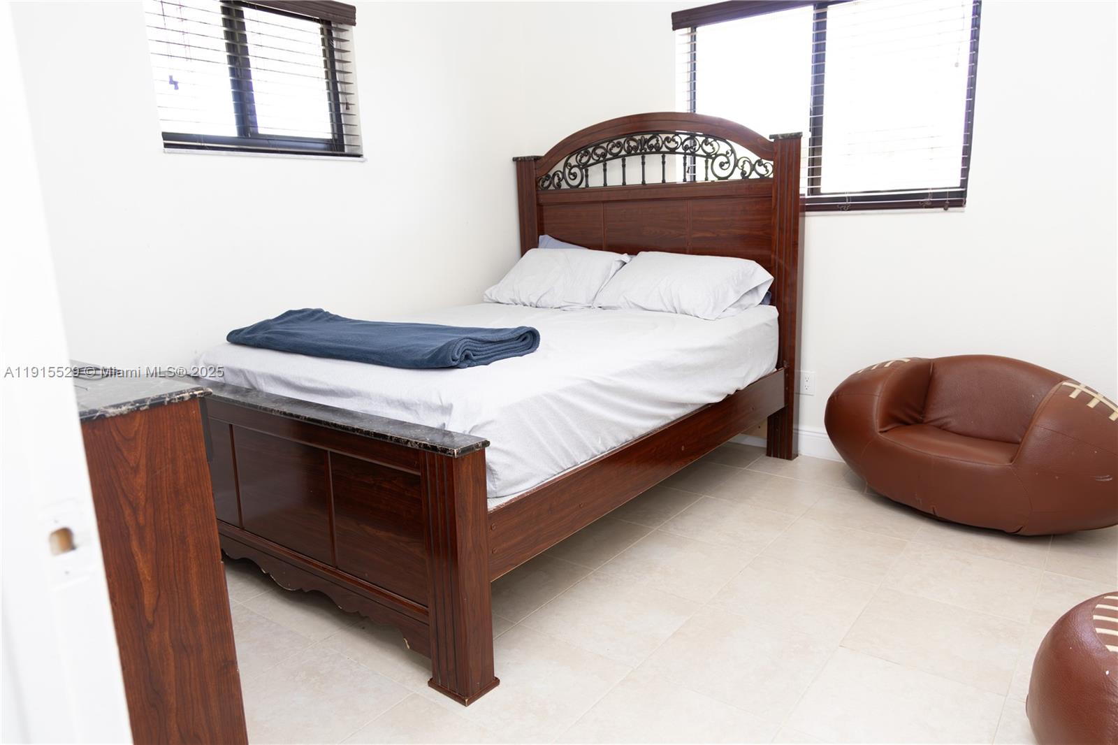 14280 Southwest 285th Street, Unit A Homestead, FL 33033 - Photo 12 of 18 a bedroom with a bed and a chair