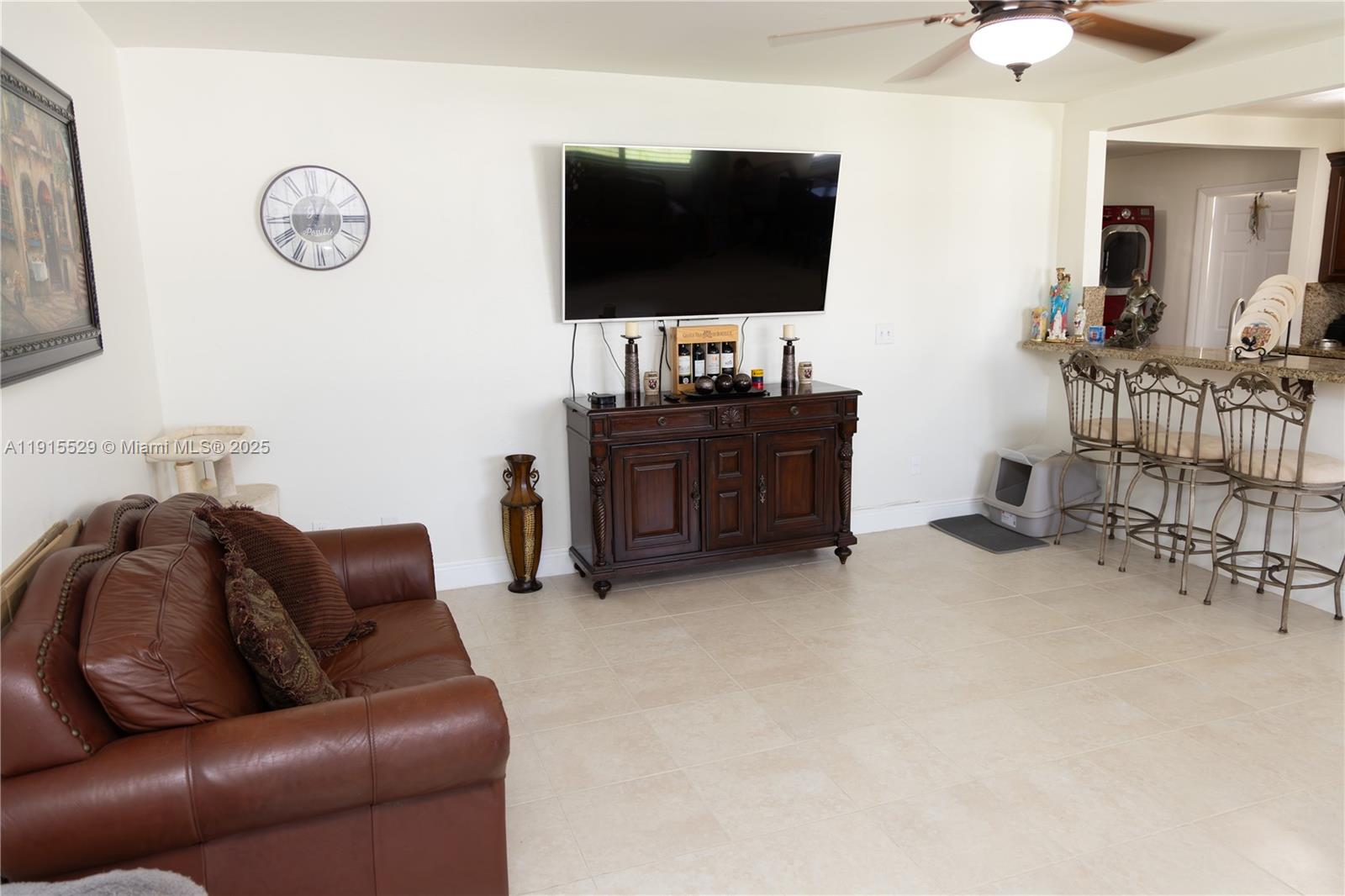14280 Southwest 285th Street, Unit A Homestead, FL 33033 - Photo 13 of 18 a living room with furniture and a flat screen tv