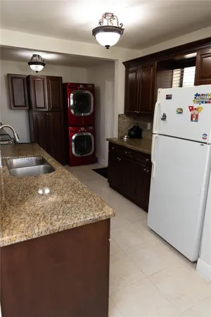 a kitchen with refrigerator and window