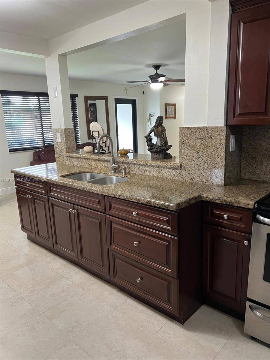 14280 Southwest 285th Street, Unit A Homestead, FL 33033 - Photo 18 of 18 a kitchen with granite countertop a sink and cabinets