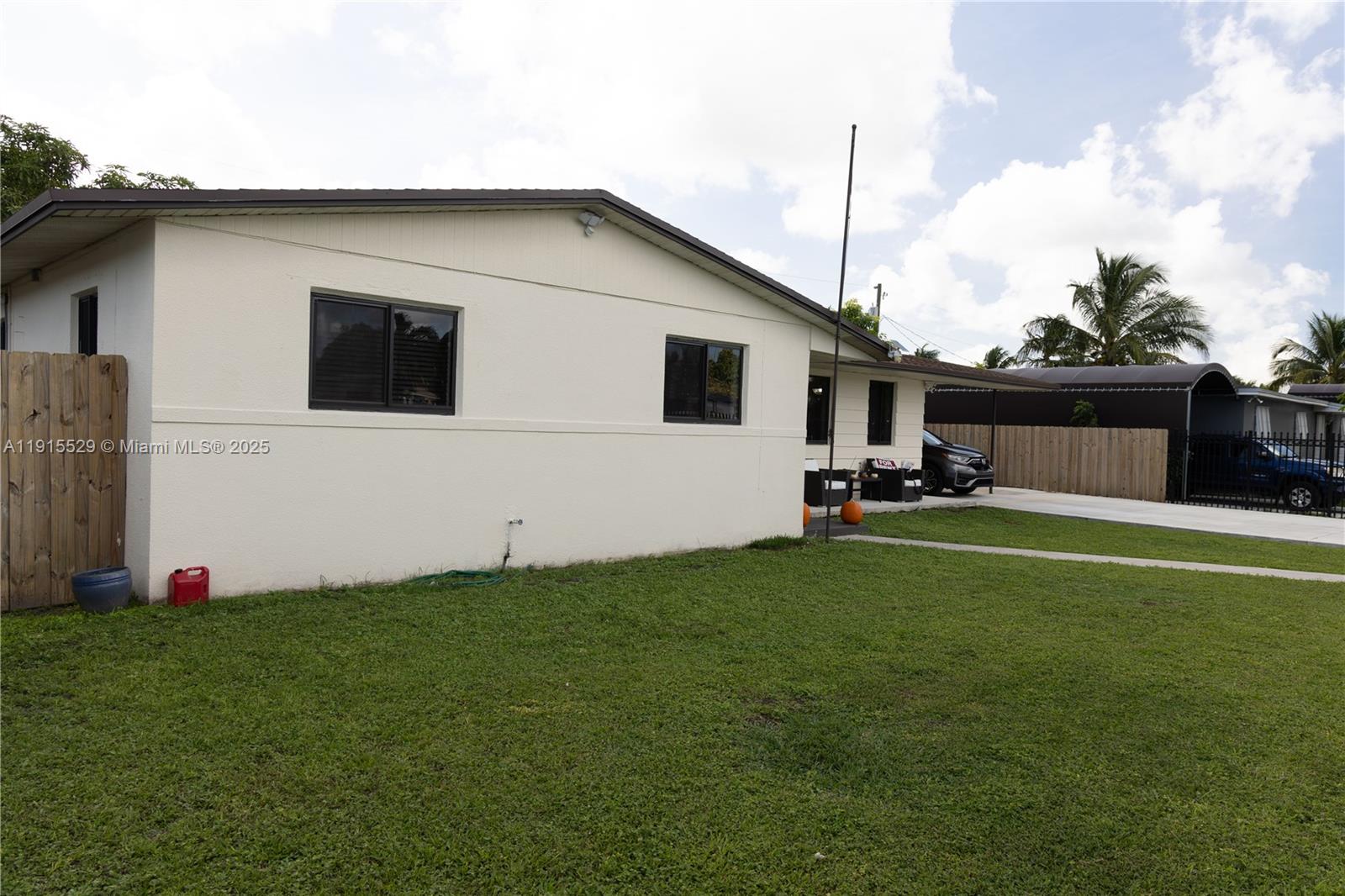 14280 Southwest 285th Street, Unit A Homestead, FL 33033 - Photo 2 of 18 a front view of house with yard
