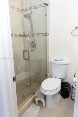 a white toilet sitting next to a bathroom sink