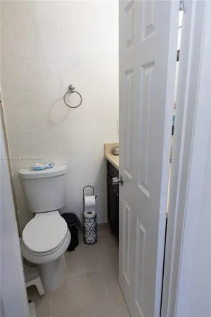 a white toilet sitting next to a sink