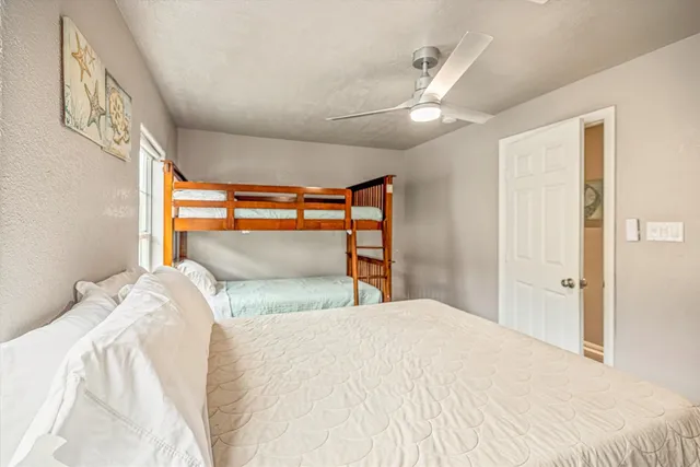 a bedroom with a large bed and a chandelier