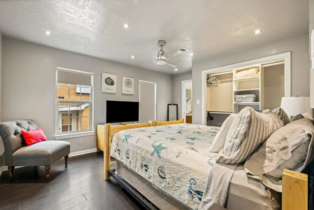 a bedroom with a bed and wooden floor