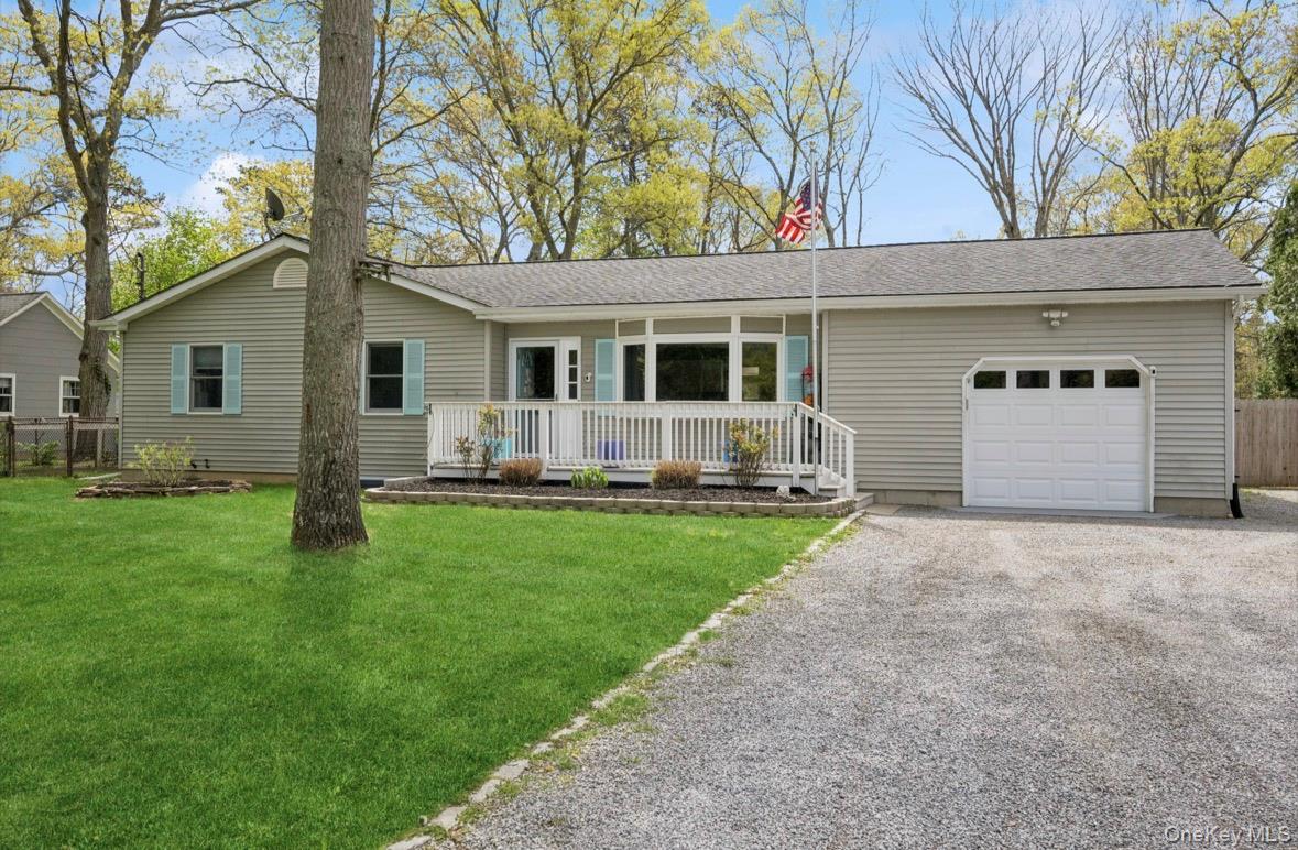 a front view of house with yard and outdoor seating