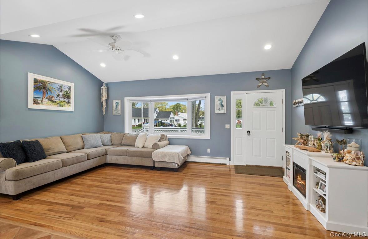 85 Old Stone Road Calverton, NY 11933 - Photo 14 of 19 a living room with furniture and wooden floor