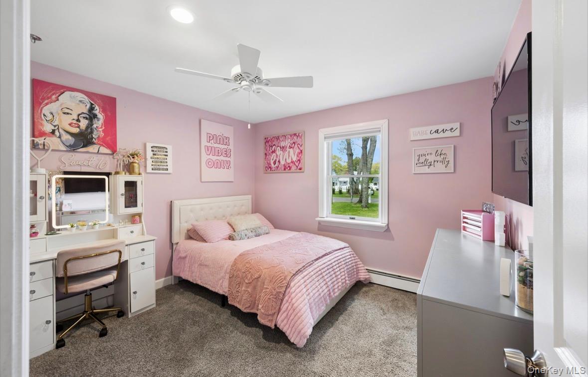 85 Old Stone Road Calverton, NY 11933 - Photo 6 of 19 a bedroom with a bed and a chandelier