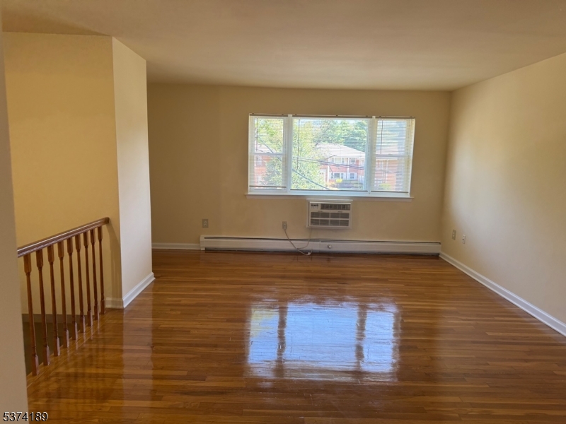 63 Traphagen Road, Unit B Wayne, NJ 07470 - Photo 4 of 18 a view of room with wooden floor and windows