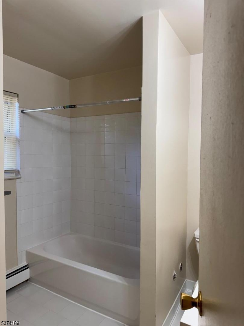 63 Traphagen Road, Unit B Wayne, NJ 07470 - Photo 6 of 18 a bathroom with a bathtub