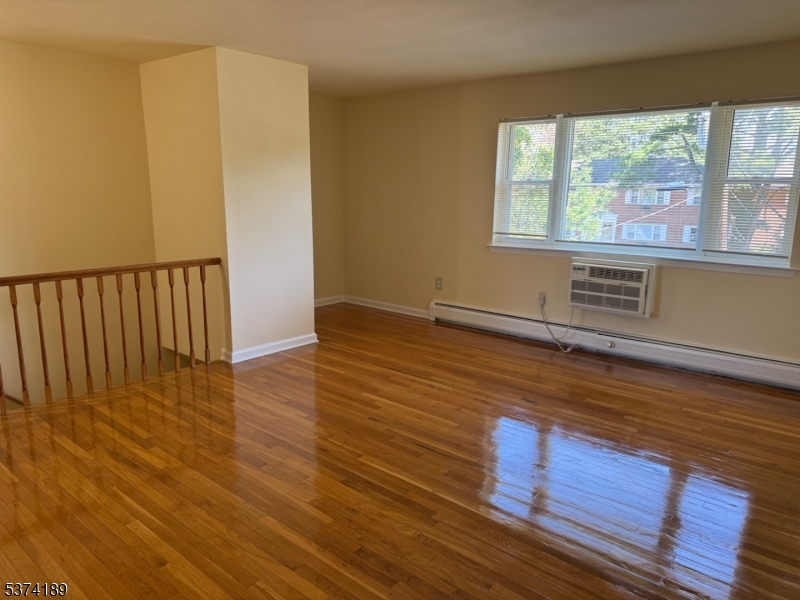 63 Traphagen Road, Unit B Wayne, NJ 07470 - Photo 9 of 18 a view of an empty room with wooden floor and a window
