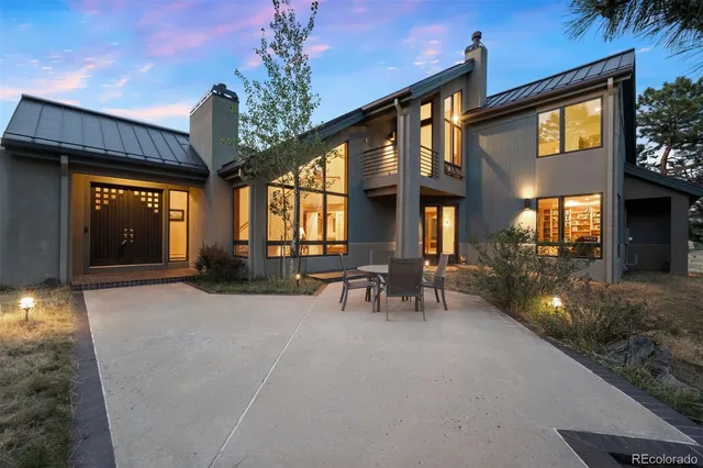 a view of a house with patio and a yard