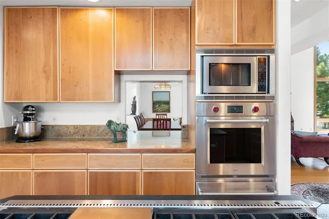 a kitchen with microwave a stove and cabinets