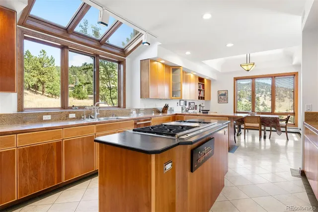 a kitchen with stainless steel appliances granite countertop sink stove top oven and cabinets