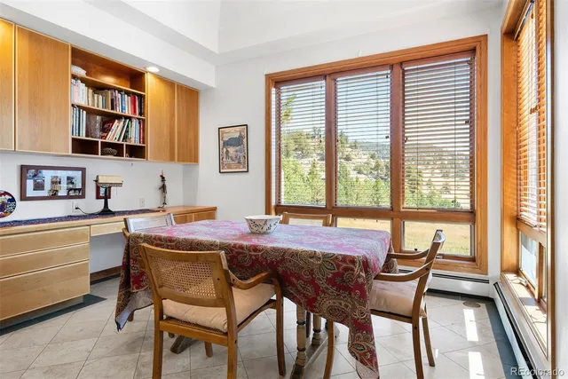 a view of a dining room with furniture and a window