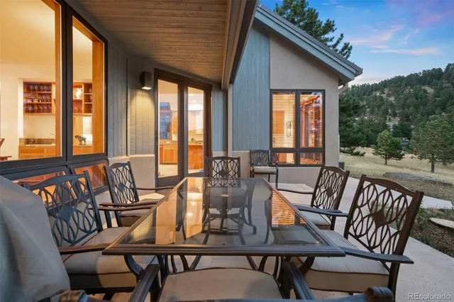 a view of a patio with table and chairs