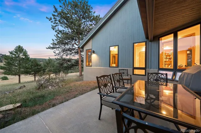 a view of a patio with a table chairs and backyard
