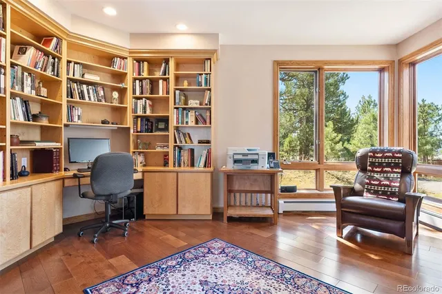 a view of a livingroom with workspace and a window