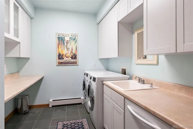 a utility room with sink dryer and washer