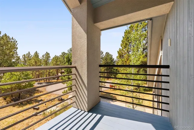 a view of a balcony with wooden floor and outdoor space