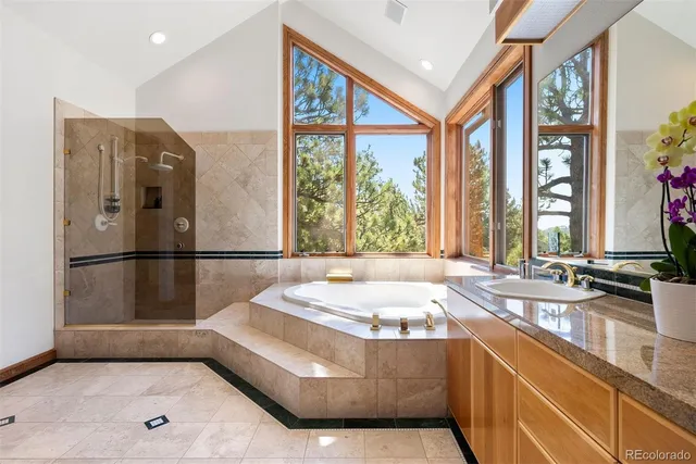 a spacious bathroom with a tub and large windows