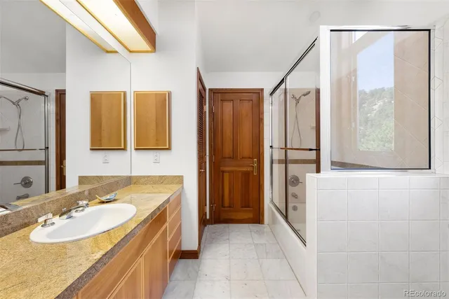 a bathroom with a tub sink and mirror