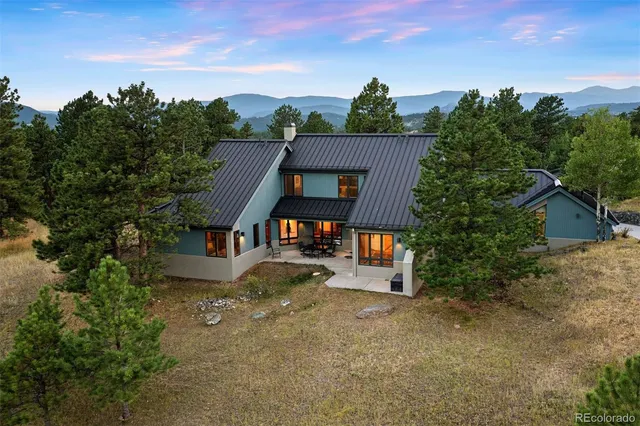 a view of a house with a mountain yard