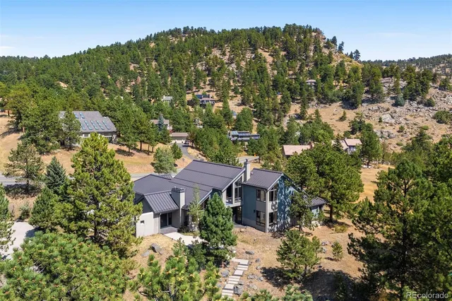 a view of a lush green hillside and houses