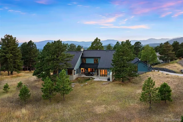 an aerial view of a house with a yard basket ball court and outdoor seating