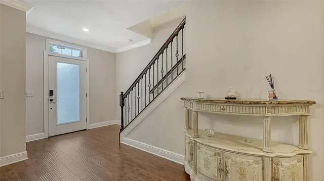 a view of a livingroom with wooden floor and staircase