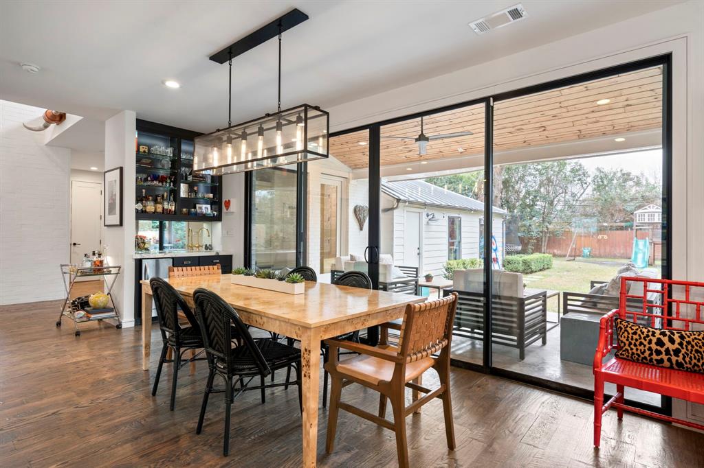 6605 Robin Road Dallas, TX 75209 - Photo 12 of 28 a dining room with furniture window wooden floor and a chandelier