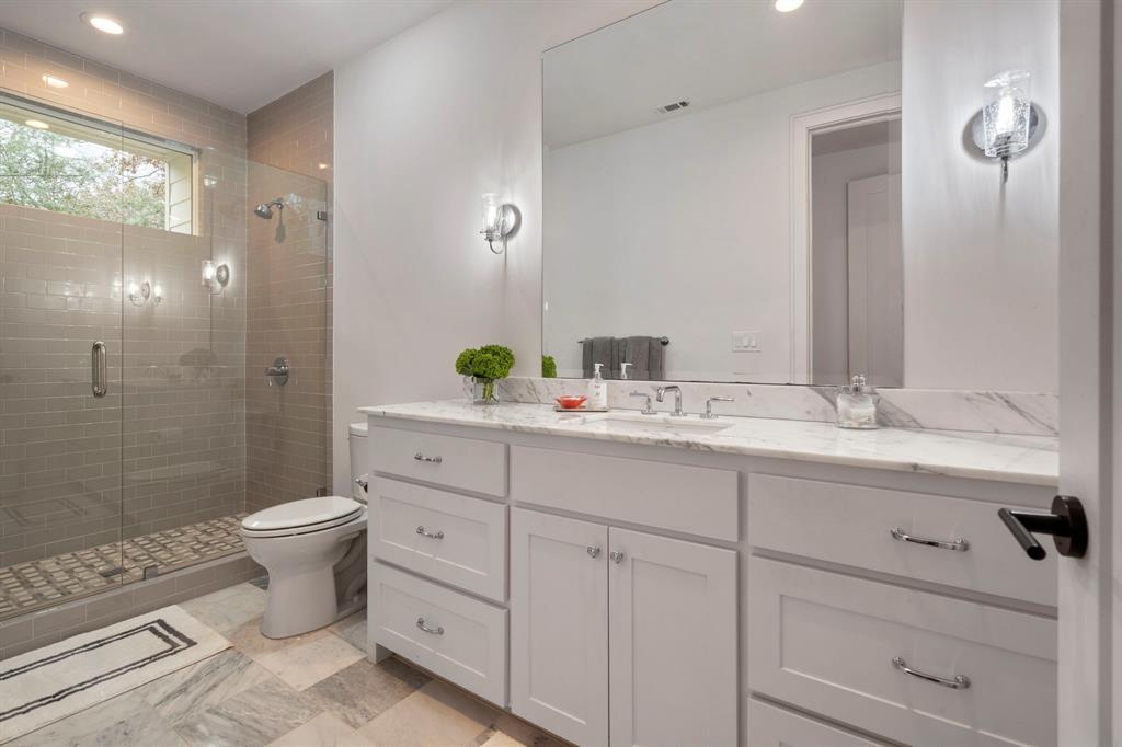6605 Robin Road Dallas, TX 75209 - Photo 18 of 28 a bathroom with a double vanity sink toilet and shower