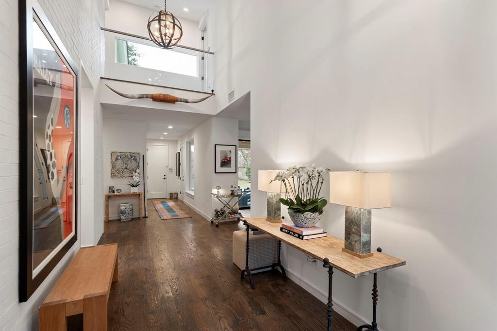 6605 Robin Road Dallas, TX 75209 - Photo 2 of 28 a view of a hallway that has a couch and a chandelier