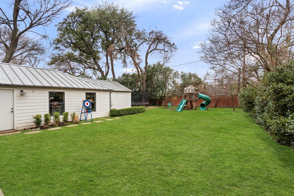 6605 Robin Road Dallas, TX 75209 - Photo 27 of 28 a front view of a house with a yard and trees