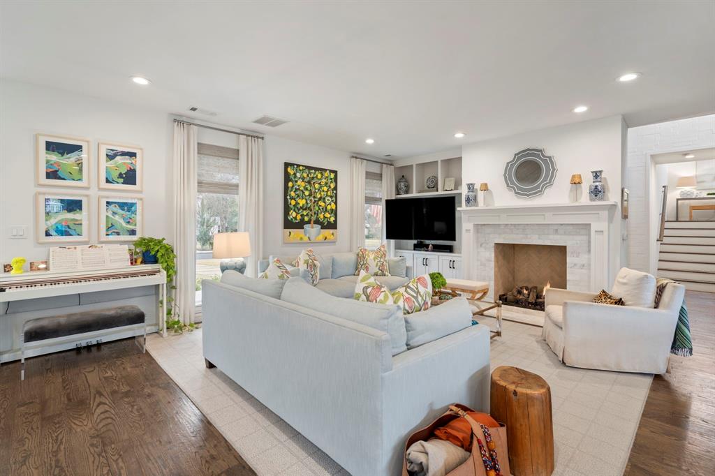 6605 Robin Road Dallas, TX 75209 - Photo 4 of 28 a living room with furniture a fireplace and a flat screen tv