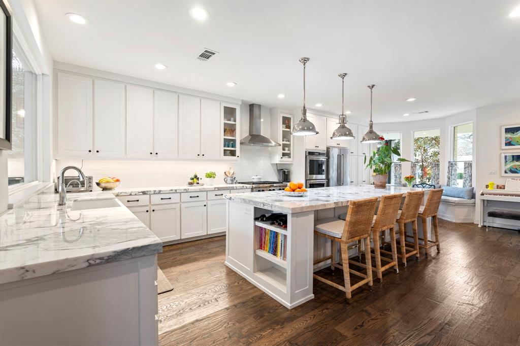 6605 Robin Road Dallas, TX 75209 - Photo 9 of 28 a kitchen with stainless steel appliances kitchen island granite countertop a sink and cabinets