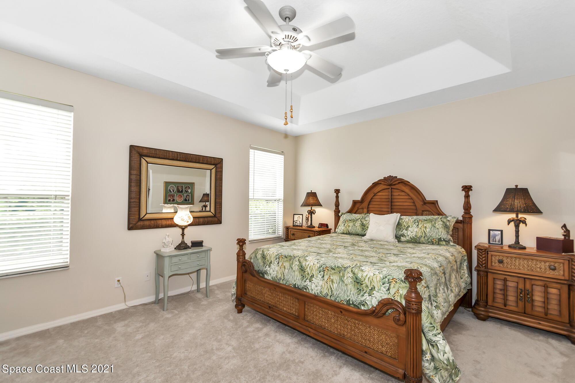 569 Renaissance Avenue Melbourne, FL 32940 - Photo 14 of 34 a bedroom with a bed a chandelier and dresser