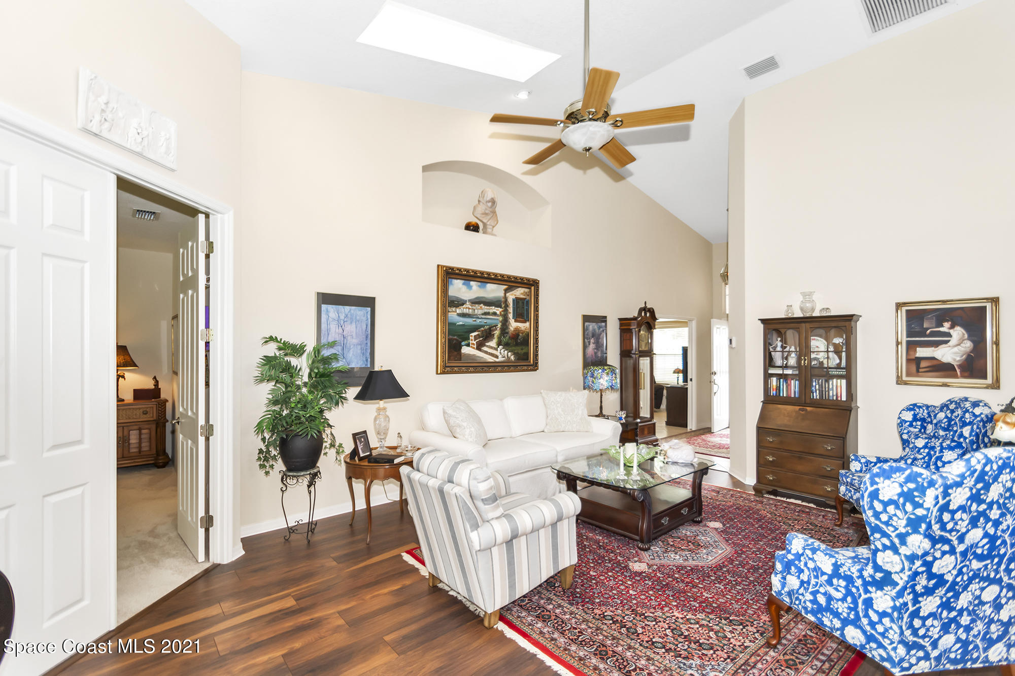 569 Renaissance Avenue Melbourne, FL 32940 - Photo 5 of 34 a living room with furniture and a chandelier