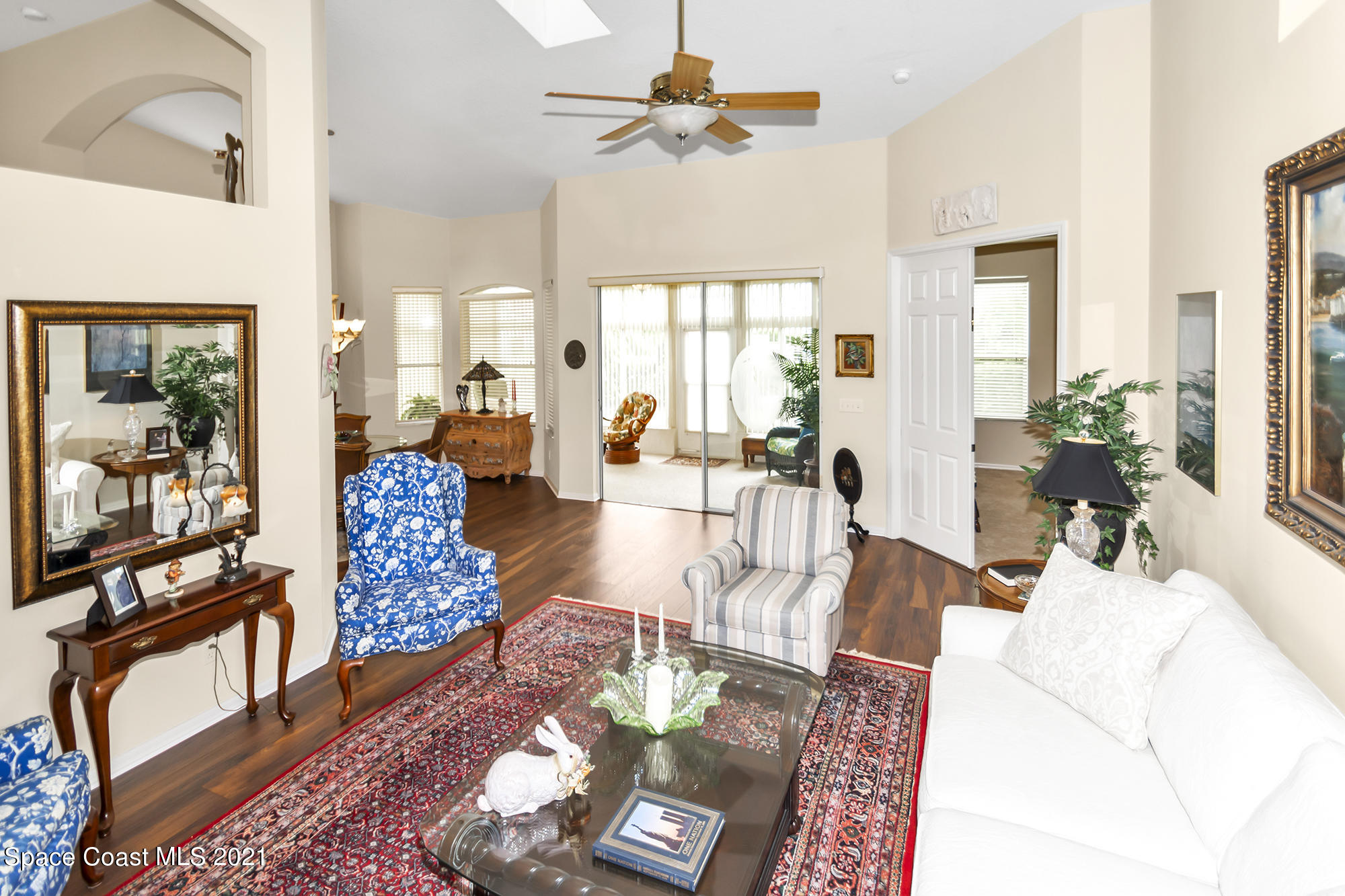 569 Renaissance Avenue Melbourne, FL 32940 - Photo 7 of 34 a living room with furniture and a chandelier