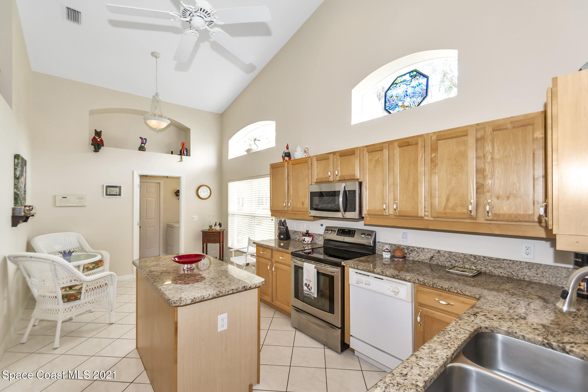 569 Renaissance Avenue Melbourne, FL 32940 - Photo 8 of 34 a kitchen with stainless steel appliances granite countertop a stove and a sink