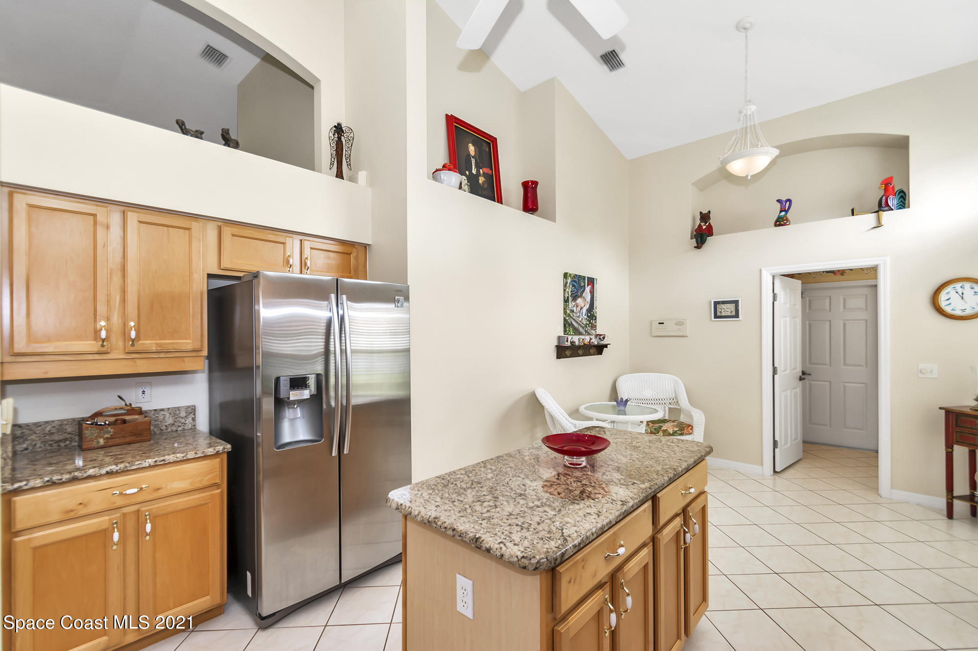 569 Renaissance Avenue Melbourne, FL 32940 - Photo 9 of 34 a kitchen with stainless steel appliances granite countertop a refrigerator and a stove