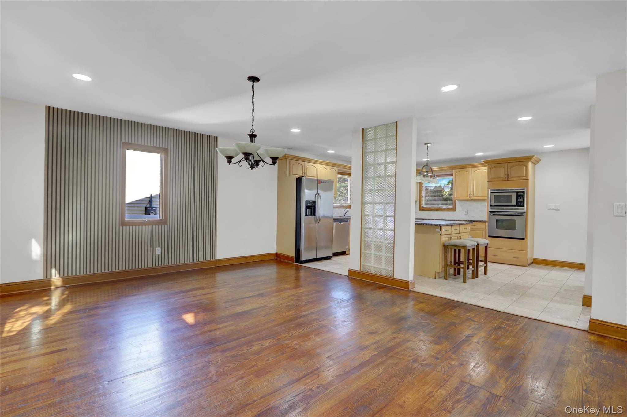 600 Plainview Road Plainview, NY 11803 - Photo 12 of 41 a view of a livingroom with furniture a chandelier and wooden floor
