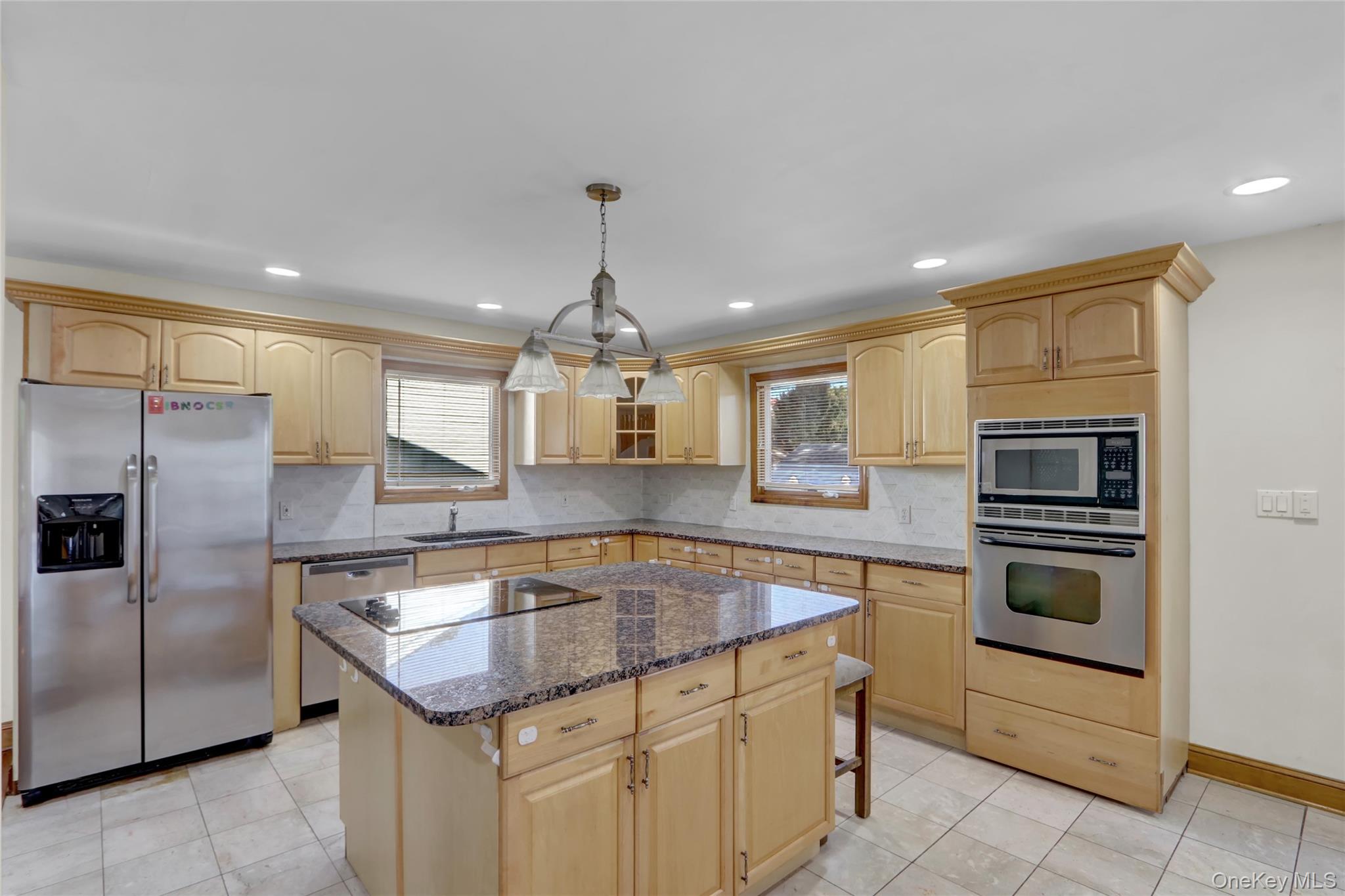 600 Plainview Road Plainview, NY 11803 - Photo 13 of 41 a kitchen with granite countertop stainless steel appliances a sink stove and refrigerator