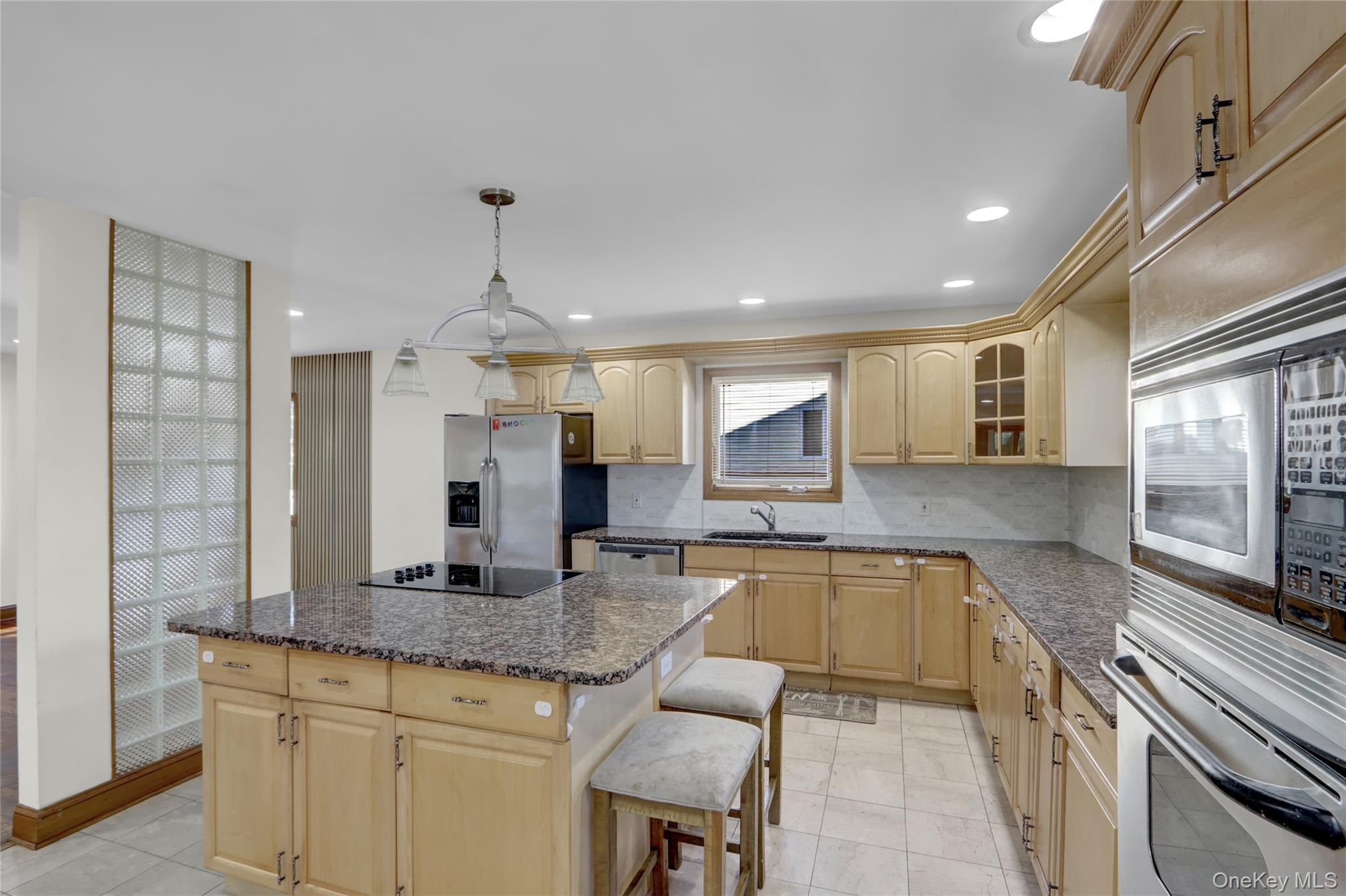 600 Plainview Road Plainview, NY 11803 - Photo 14 of 41 a large kitchen with granite countertop a stove and a sink