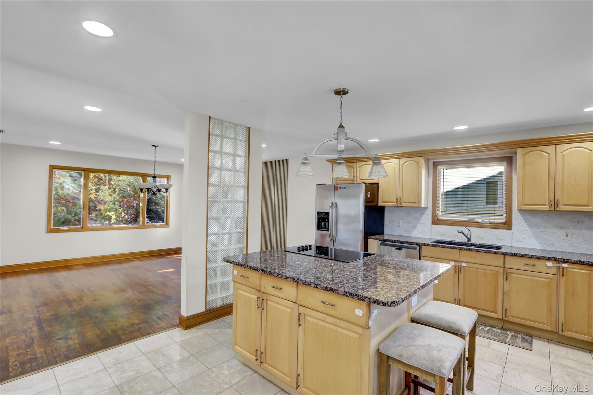 600 Plainview Road Plainview, NY 11803 - Photo 15 of 41 a kitchen with granite countertop sink cabinets and stainless steel appliances