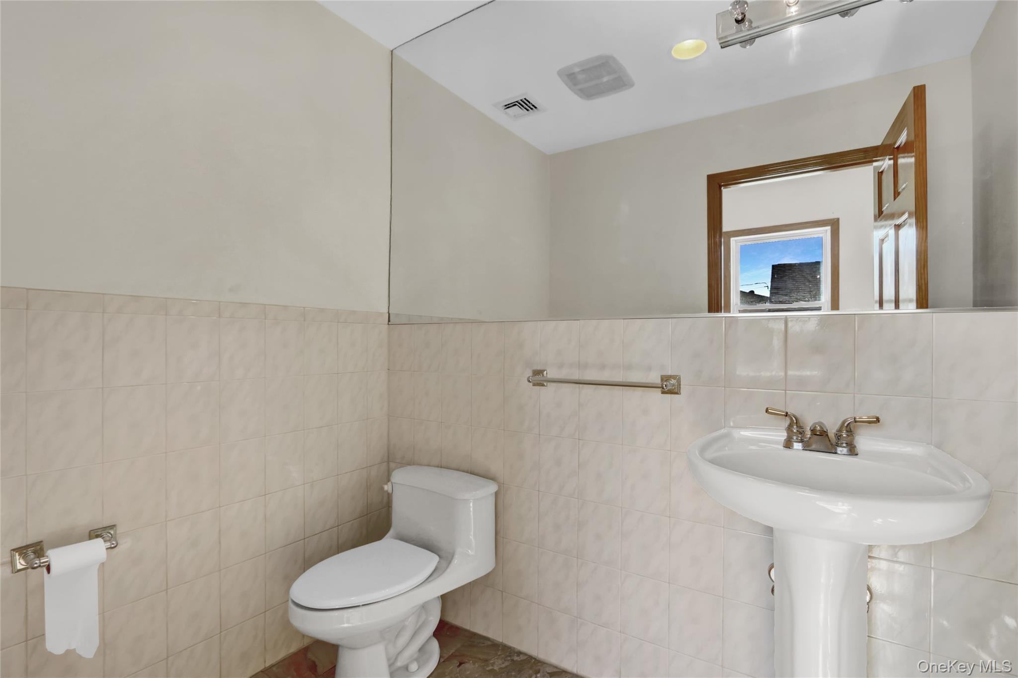 600 Plainview Road Plainview, NY 11803 - Photo 20 of 41 a bathroom with a toilet sink and mirror