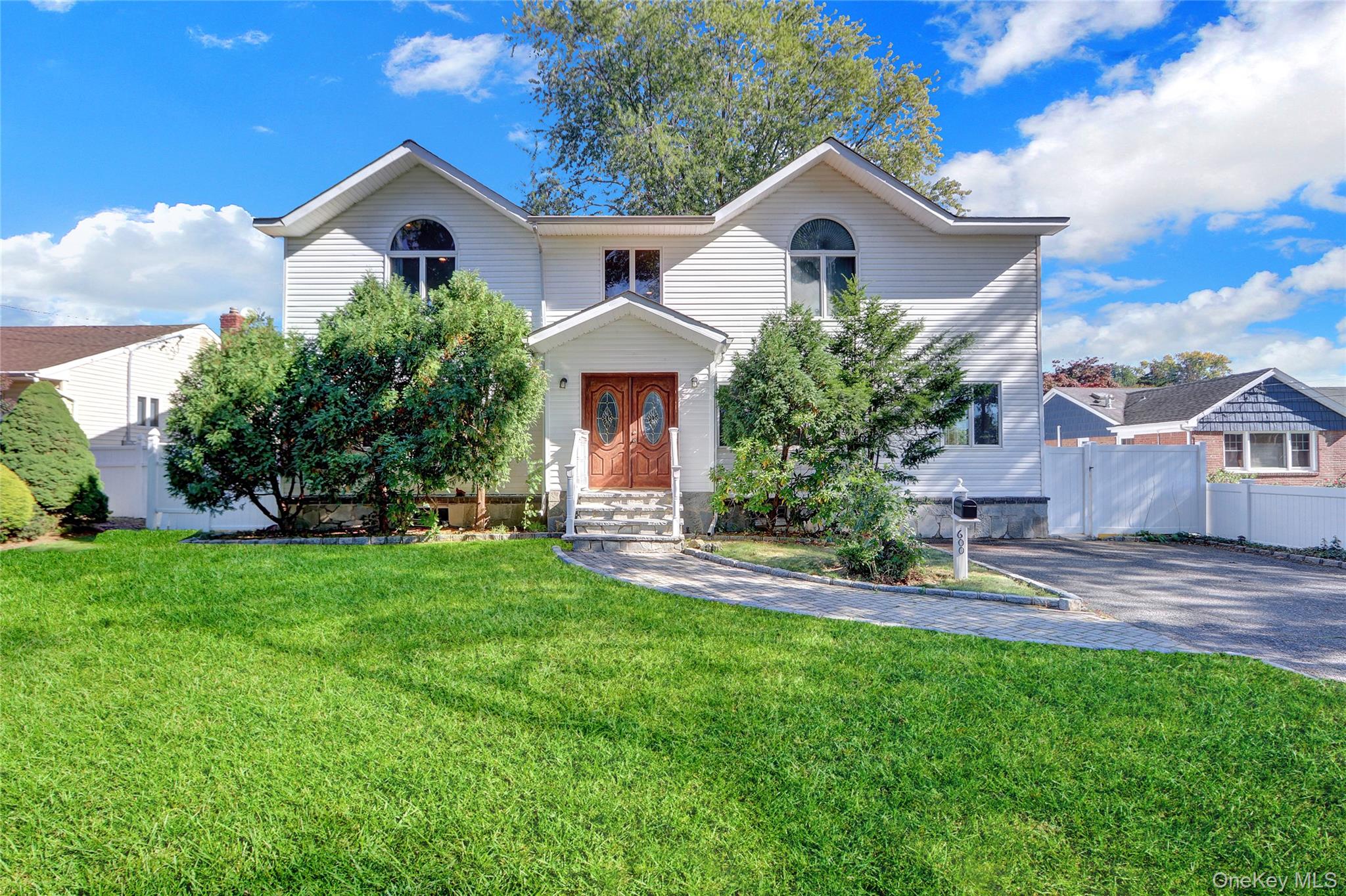 600 Plainview Road Plainview, NY 11803 - Photo 2 of 41 a front view of a house with a yard and garage
